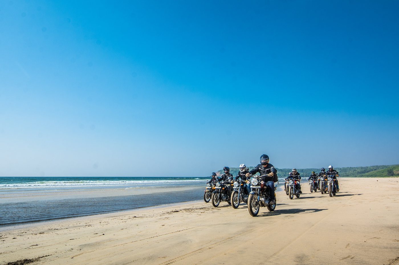 Bulleteers riders motorcycling on a beach